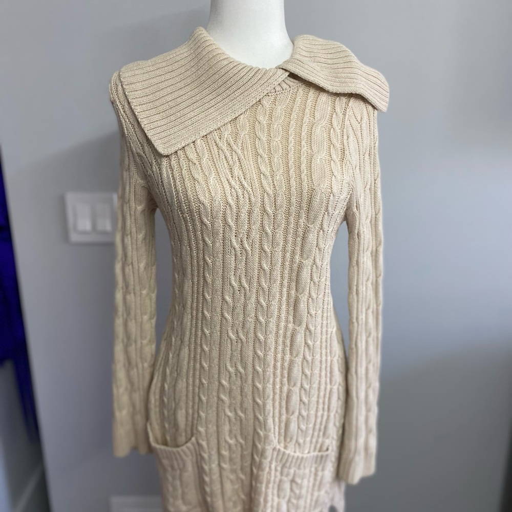 Cream colored king sweater with small paint stain
